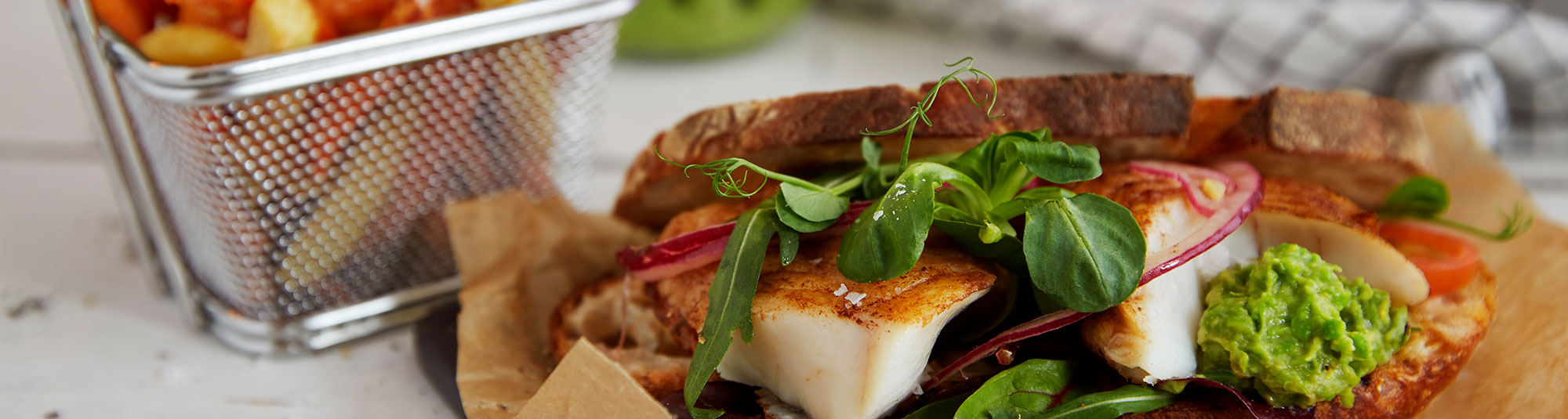 Halstrad torskrygg i rostat bröd med krispig örtsallad och ärtguacamole